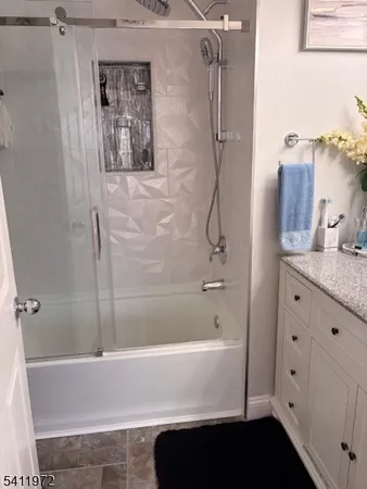 a bathroom with a bathtub and a shower