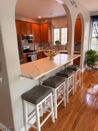 a kitchen with stainless steel appliances granite countertop a stove a sink and a microwave