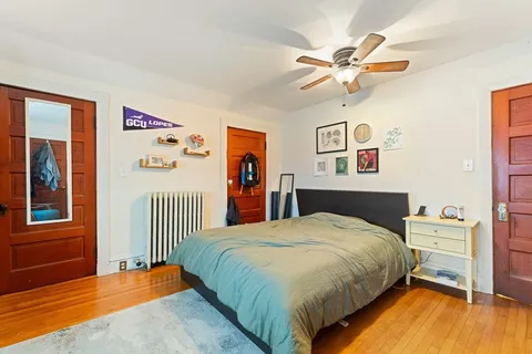 a bedroom with a bed and a chandelier