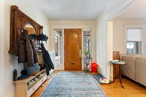 a view of an entryway with wooden floor