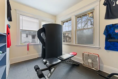 a room with gym equipment and a window