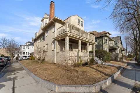 a view of a white building with many windows