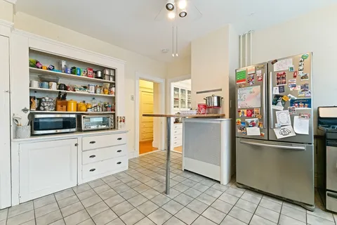 a kitchen with stainless steel appliances cabinets and a window