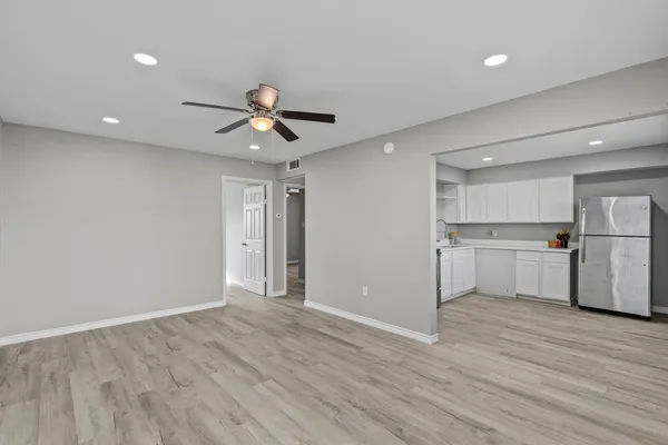 a view of a kitchen with a sink and a refrigerator