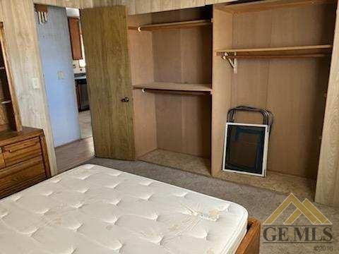 Undisclosed Address Ridgecrest, CA 93555 - Photo 11 of 30 a bedroom with a bed and a dresser