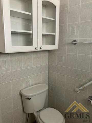 Undisclosed Address Ridgecrest, CA 93555 - Photo 15 of 30 a bathroom with a toilet a sink and mirror