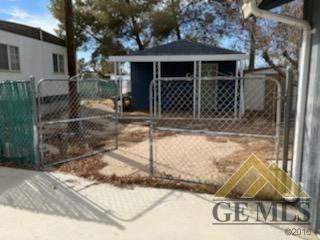 Undisclosed Address Ridgecrest, CA 93555 - Photo 21 of 30 a view of a house with a yard and garage
