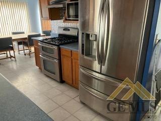 Undisclosed Address Ridgecrest, CA 93555 - Photo 6 of 30 a kitchen with stainless steel appliances granite countertop a stove a sink and a refrigerator