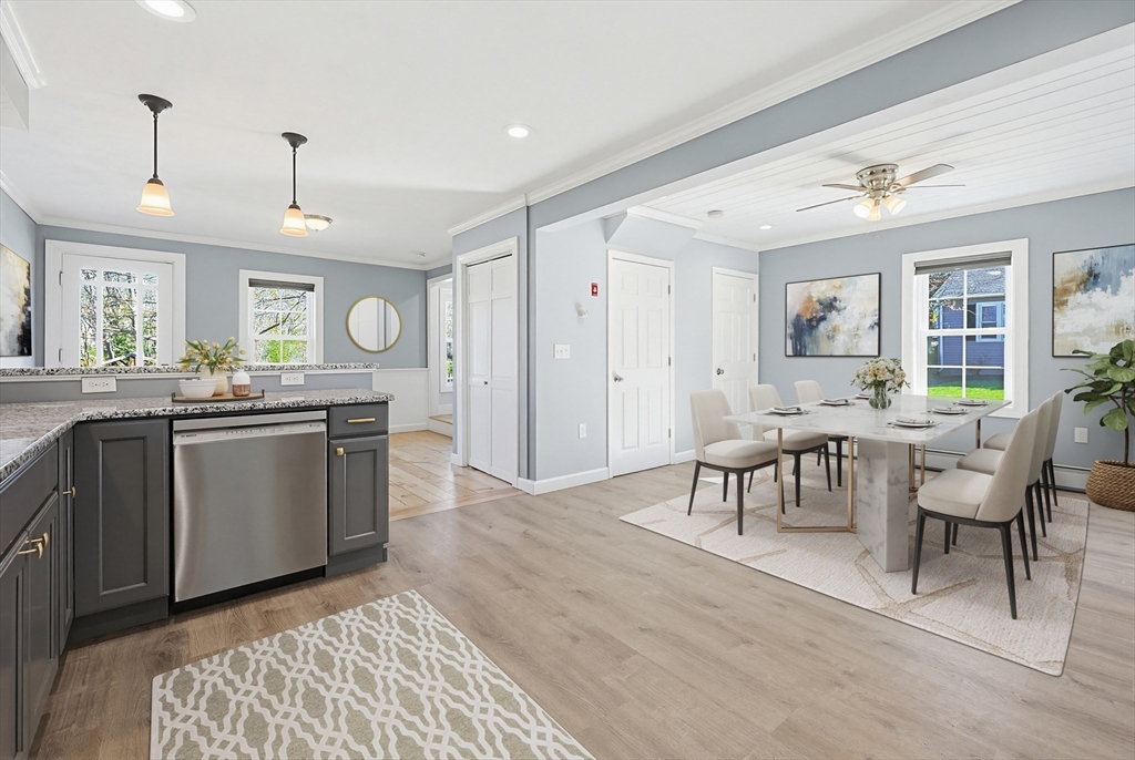 44 Clark Street Spencer, MA 01562 - Photo 10 of 41 a open kitchen with stainless steel appliances granite countertop a stove a sink dishwasher a dining table and chairs with wooden floor