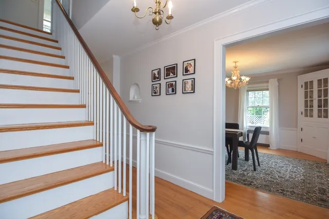 a view of a hallway to a livingroom with furniture and windows