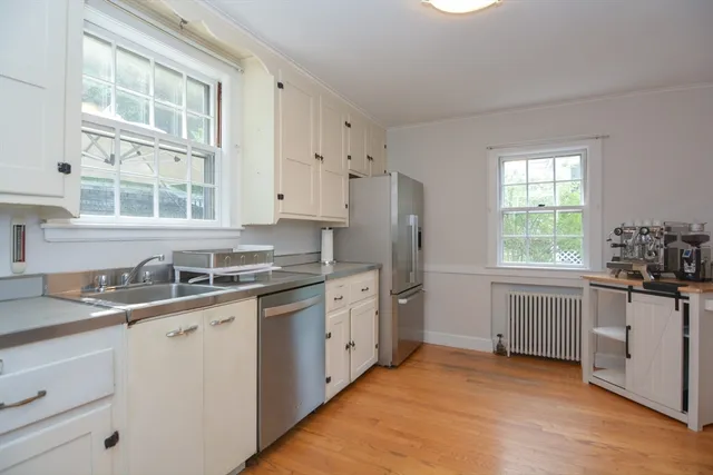 a kitchen with granite countertop a sink stove and refrigerator
