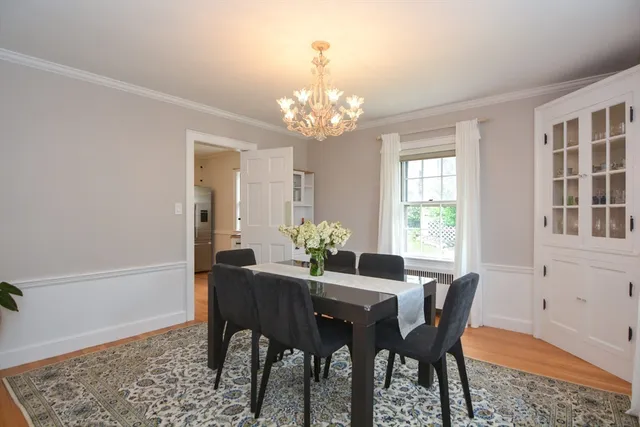 a view of a dining room with furniture and chandelier