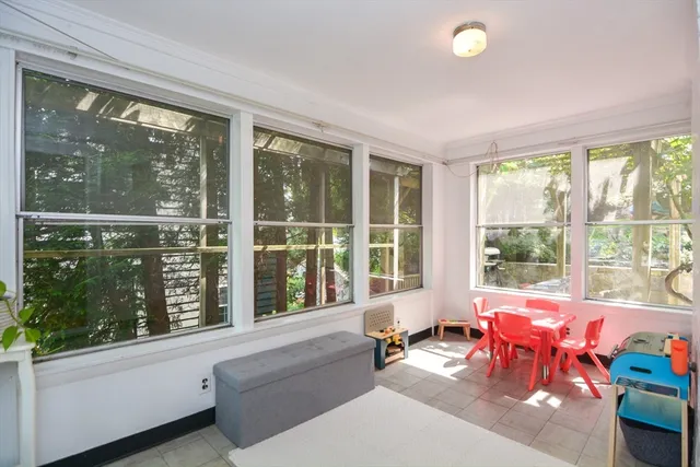 a living room filled with furniture and floor to ceiling windows