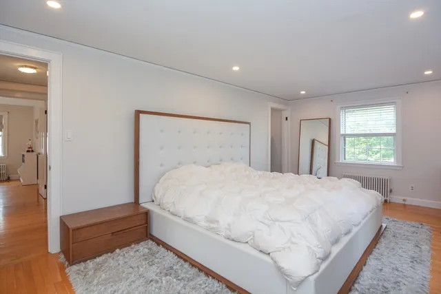 a large white bed in a white room
