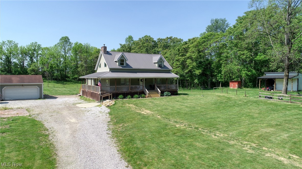 8498 Euga Road Newcomerstown, OH 43832 - Photo 48 of 49 Farmhouse inspired home with covered porch, a chimney, an outbuilding, and driveway