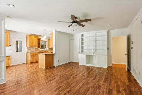 a view of a kitchen with wooden floor and a kitchen