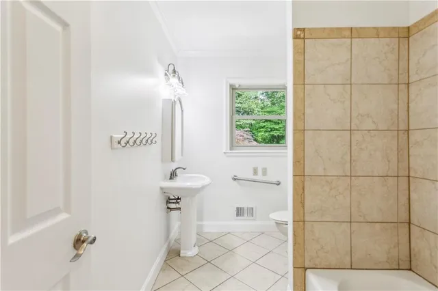 a bathroom with a sink a toilet and a shower