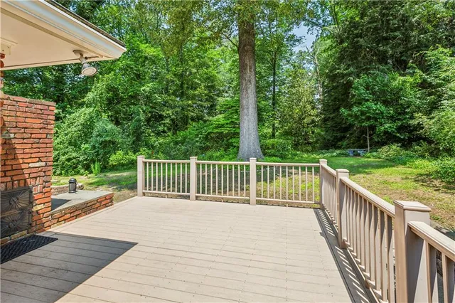 a view of a wooden deck next to a yard