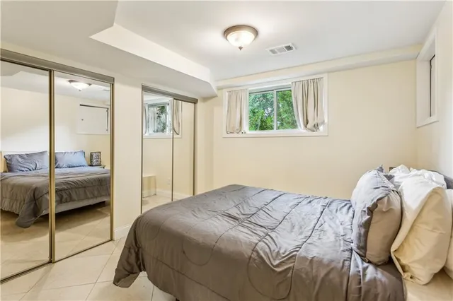 a bedroom with a bed and a mirror