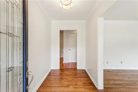 a view of a hallway with wooden floor