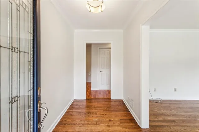 a view of a hallway with wooden floor