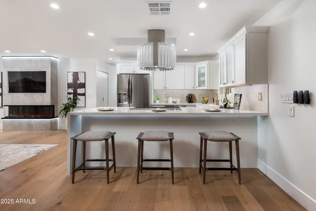 a kitchen with a sink cabinets and wooden floor