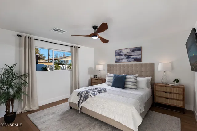 a living room with furniture and a ceiling fan