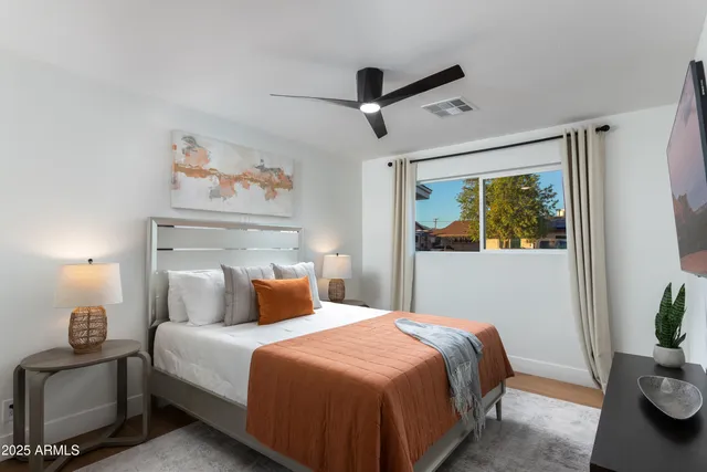 a bedroom with a bed and a flat screen tv