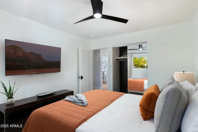 a bedroom with a bed and wooden floor