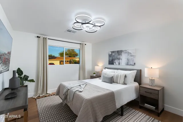 a bedroom with a bed and a flat screen tv