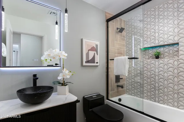 a utility room with cabinets washer and dryer