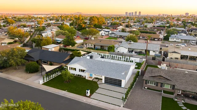 an aerial view of residential houses with city view