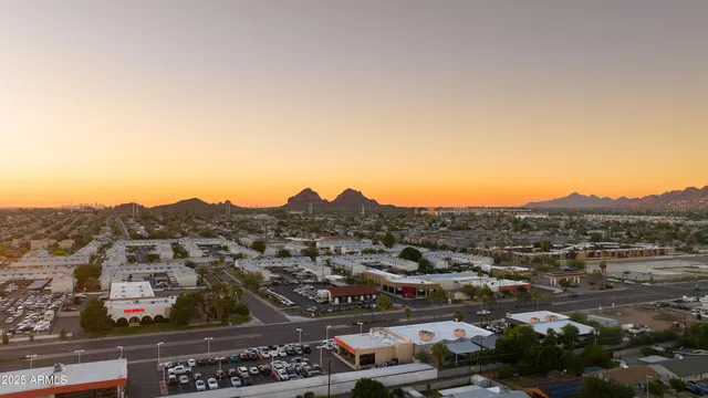 an aerial view of residential houses with city view