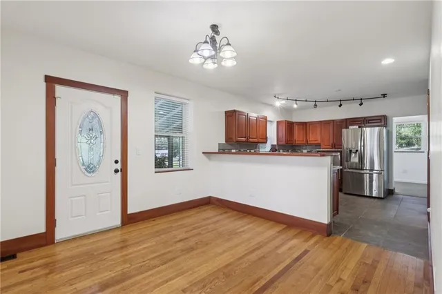 a kitchen with stainless steel appliances granite countertop a refrigerator sink and cabinets