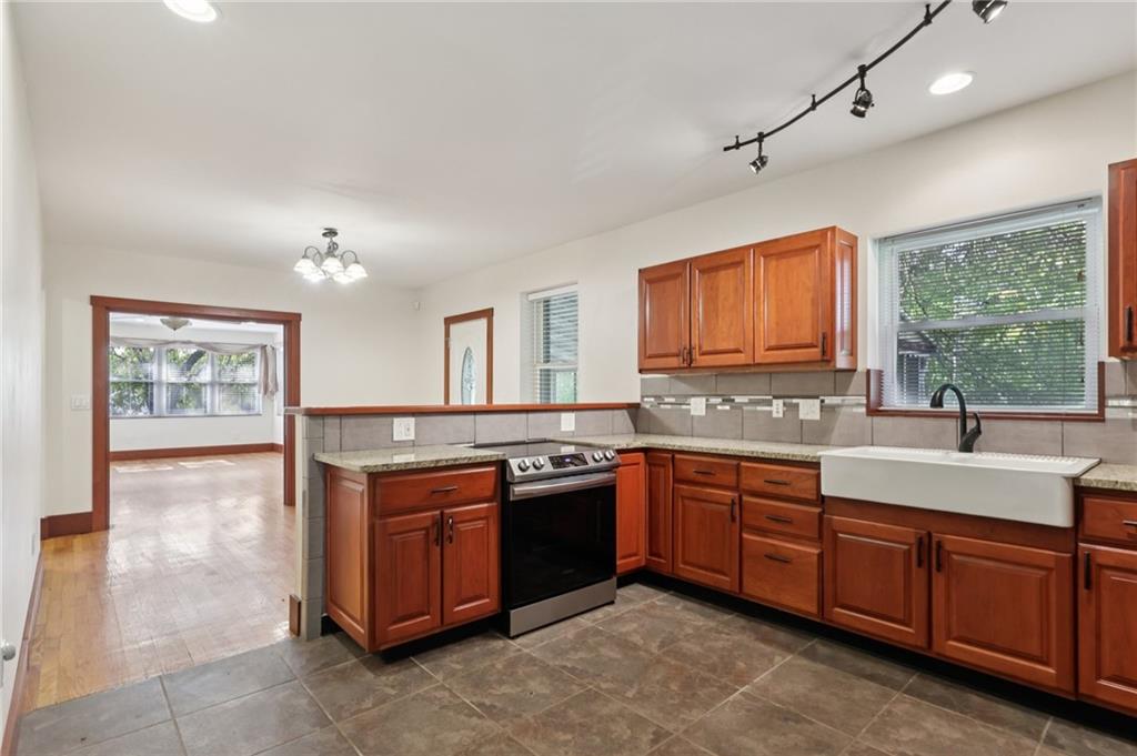 115 Enon Road Darlington, PA 16115 - Photo 14 of 50 a kitchen with a sink stove and cabinets