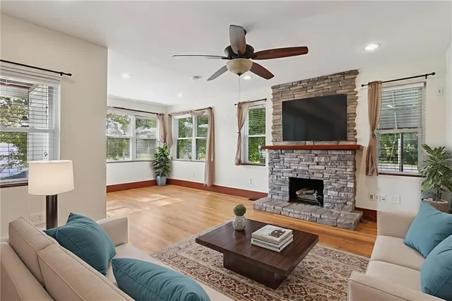 a living room with furniture fireplace and window