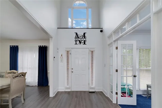 a living room with fireplace furniture flat screen tv and wooden floor