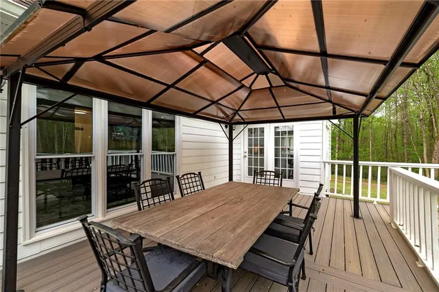 a living room with stainless steel appliances kitchen island granite countertop furniture a rug and a window