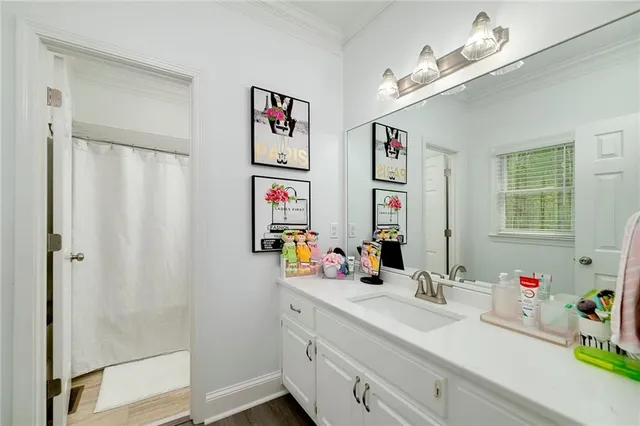 a bathroom with a tub a sink and a window