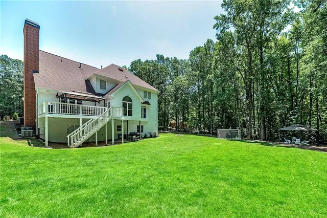 a view of patio with table and chairs under an umbrella with wooden floor