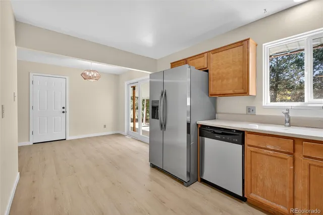 a kitchen with a refrigerator and a sink