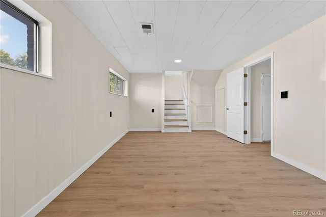 a view of empty room with wooden floor