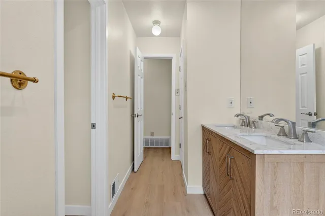 a bathroom with a sink a mirror and a shower