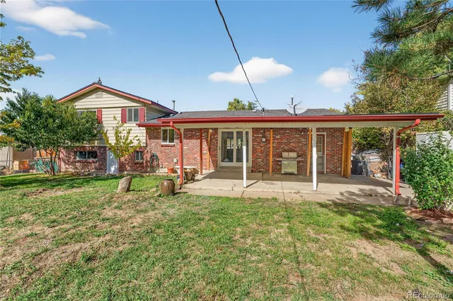 a view of a house with a yard and sitting area
