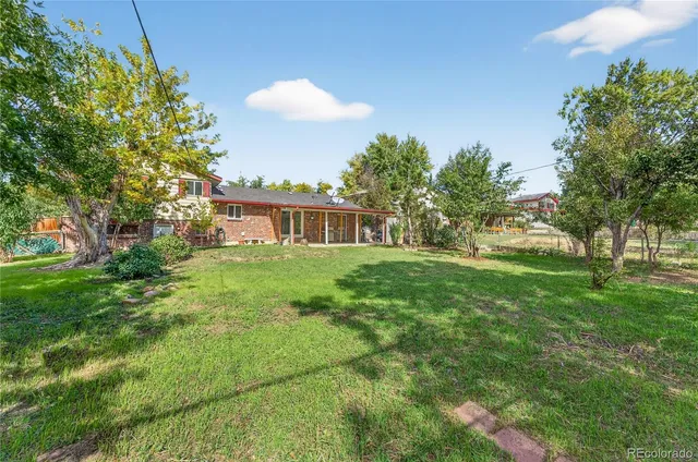 a view of a house with a backyard