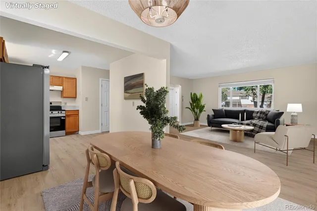 a living room with furniture potted plant and a table