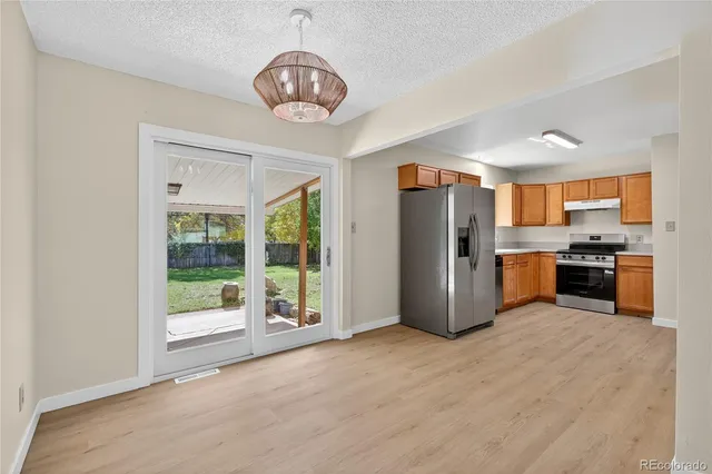 a kitchen with stainless steel appliances granite countertop a refrigerator and a sink