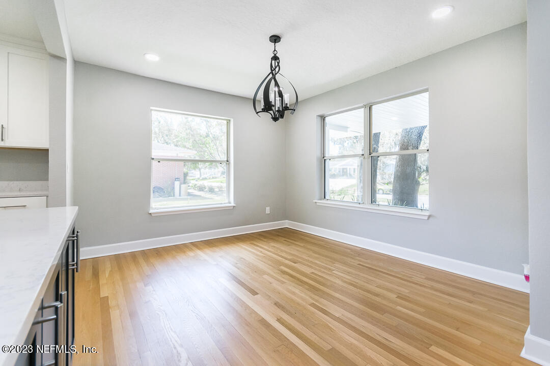 905 Waterman Road South Jacksonville, FL 32207 - Photo 13 of 19 a view of an empty room with wooden floor and a window