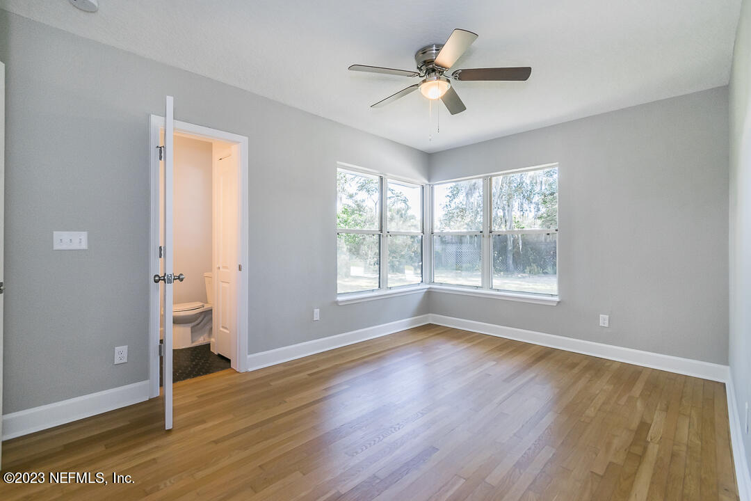 905 Waterman Road South Jacksonville, FL 32207 - Photo 14 of 19 a view of an empty room with window and wooden floor