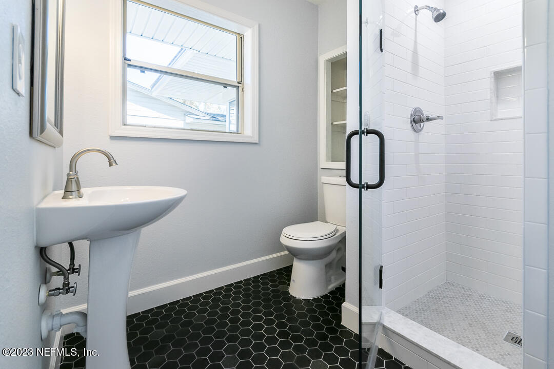 905 Waterman Road South Jacksonville, FL 32207 - Photo 17 of 19 a bathroom with a sink toilet and shower